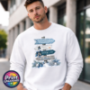 Snow-covered signpost pointing to Winter Wonderland, Frosty’s Freeze, Silver Bell Lane and the Ice Palace, with blue and silver decorations, printed on a white unisex sweatshirt male model - Print Unleashed