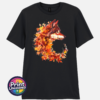 Wolf in profile with a golden eye and fur blending into red, orange and golden autumn leaves on a unisex T-shirt black - Print Unleashed