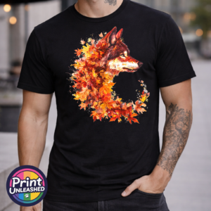 Wolf in profile with a golden eye and fur blending into red, orange and golden autumn leaves on a unisex T-shirt model - Print Unleashed