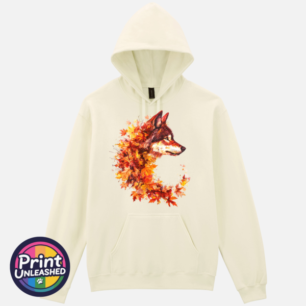 Wolf in profile with a golden eye and fur blending into red, orange and golden autumn leaves on a softstyle hoodie off white - Print Unleashed