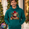 Model wearing a Classic Hoodie featuring a fluffy Highland calf in a red Christmas hat and checked scarf, surrounded by presents and festive decorations, male model - Print Unleashed