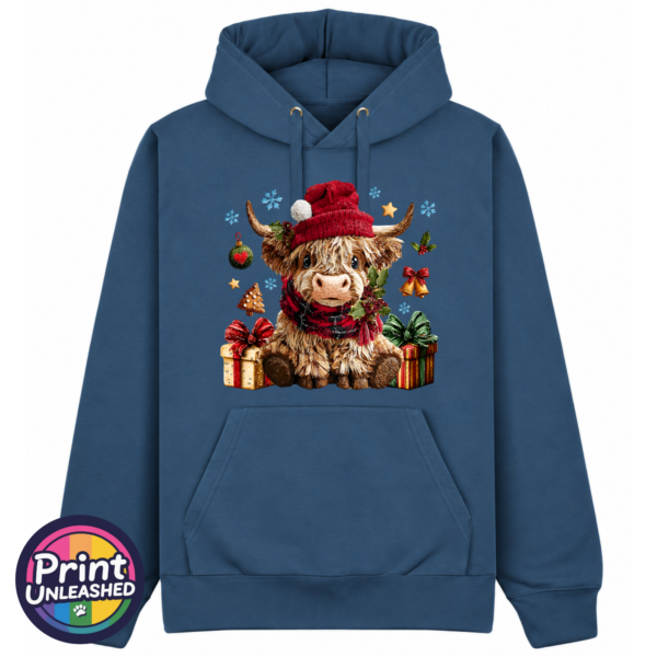 Model wearing a Classic Hoodie featuring a fluffy Highland calf in a red Christmas hat and checked scarf, surrounded by presents and festive decorations, petrol colour - Print Unleashed