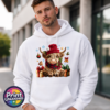 Yarn-style Highland cow wearing a red hat and checked scarf, surrounded by presents, holly, bells and snowflakes, printed on a white unisex hoodie male model - Print Unleashed