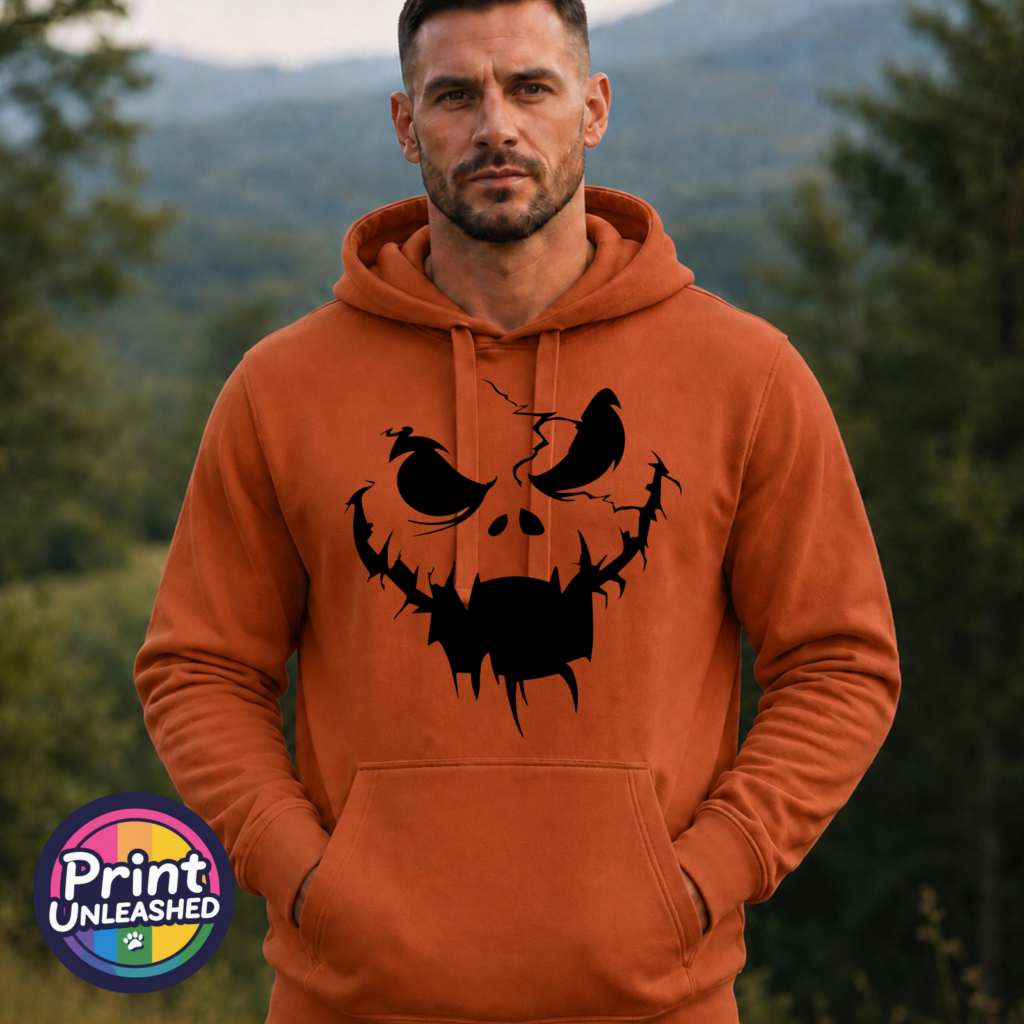 Cracked pumpkin face with scowling eyes and a wide fanged mouth on a Texas Orange Softstyle Hoodie model - Print Unleashed