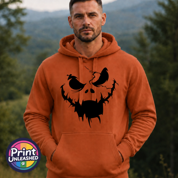 model Cracked pumpkin face with scowling eyes and a wide fanged mouth on a Texas Orange Softstyle Hoodie model - Print Unleashed