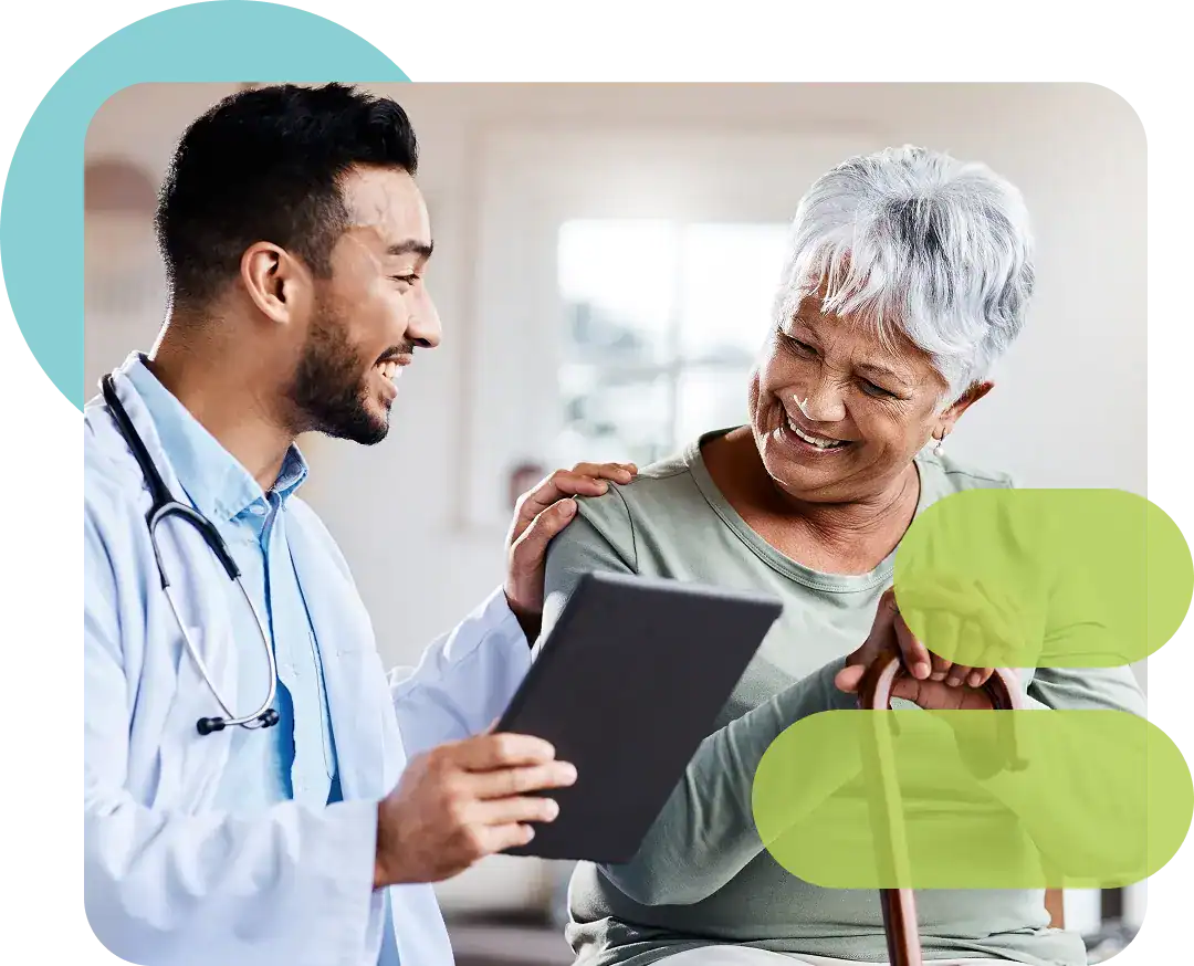 Doctor consulting with elderly patient using a tablet in a healthcare setting.