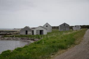 Abandoned wooden houses in a Newfoundland ghost town by the water.