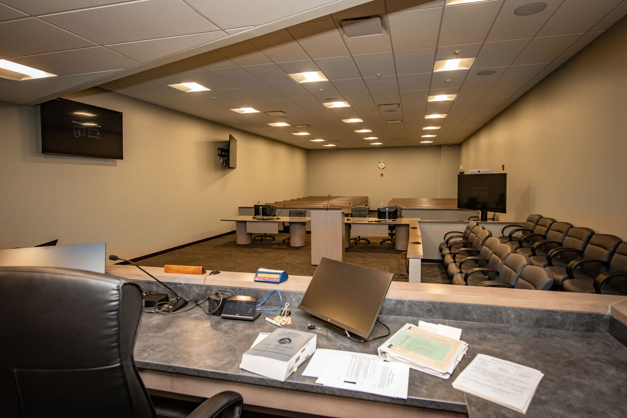 Conference room with multiple workstations and seating for meetings.
