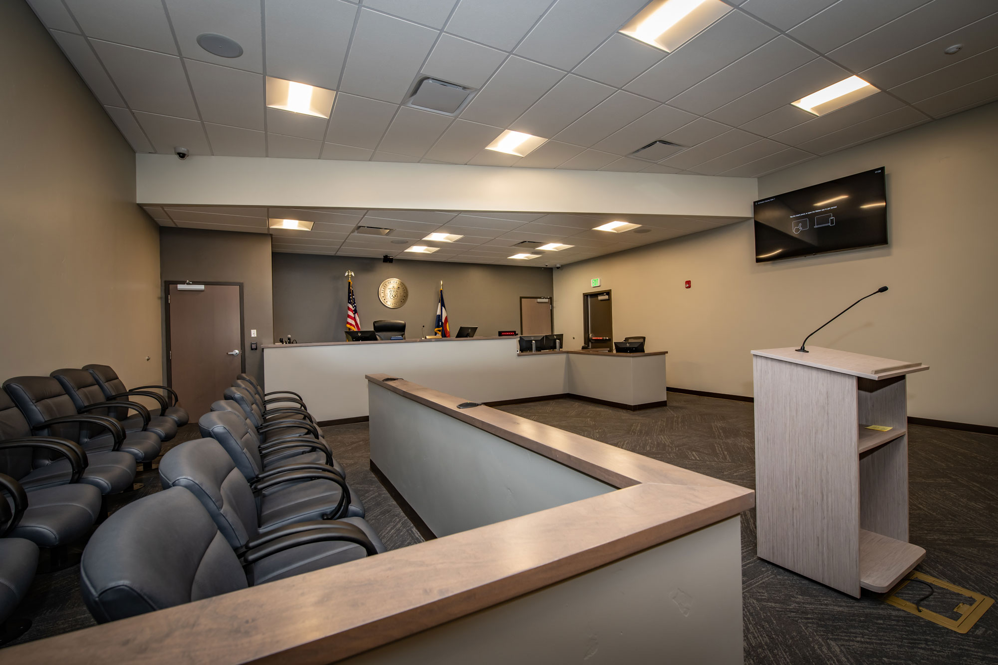 Modern conference room with seating and presentation area at Reynolds Ash + Associates.