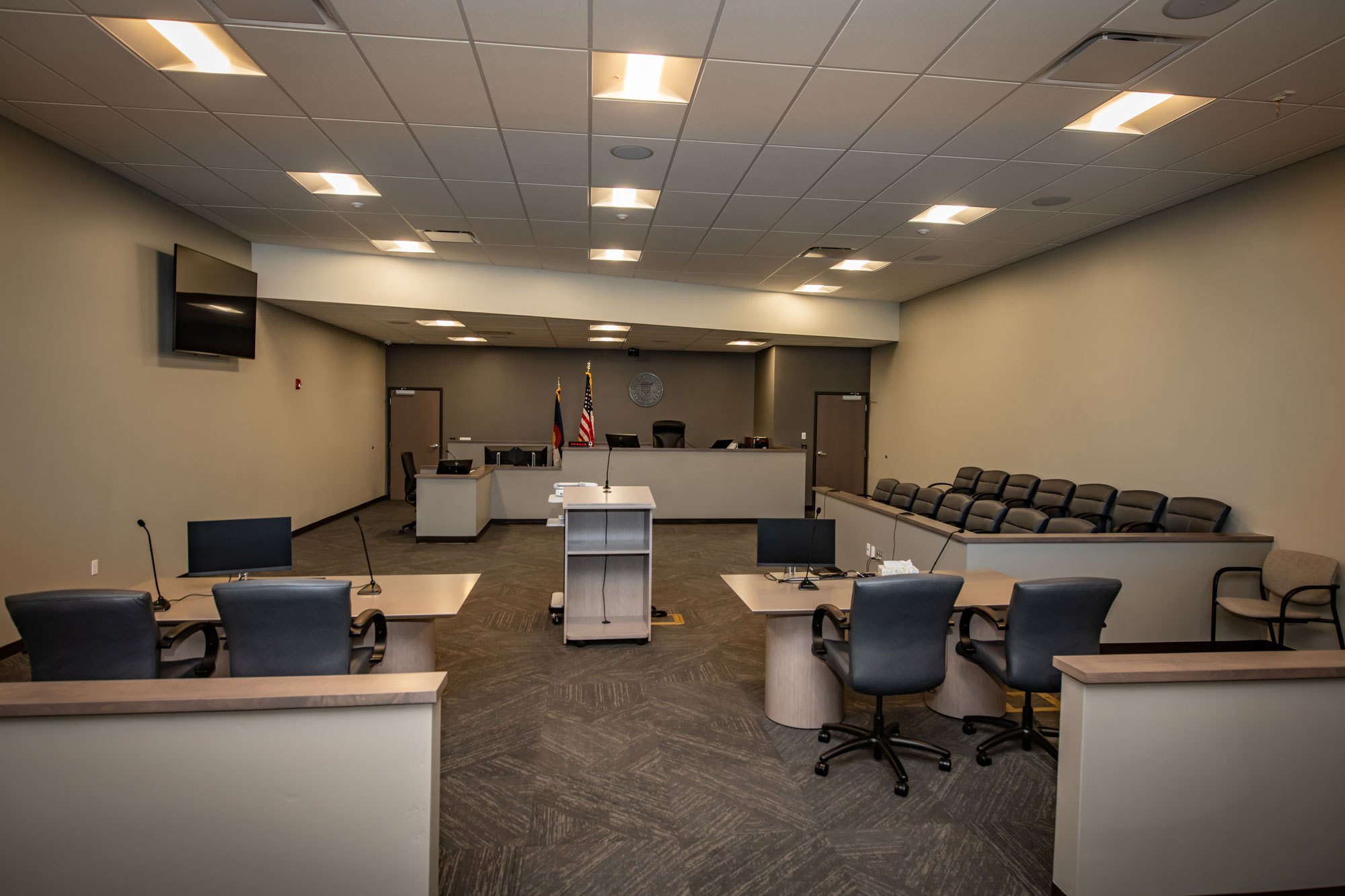 Modern courtroom with seating, presentation area, and courtroom setup.