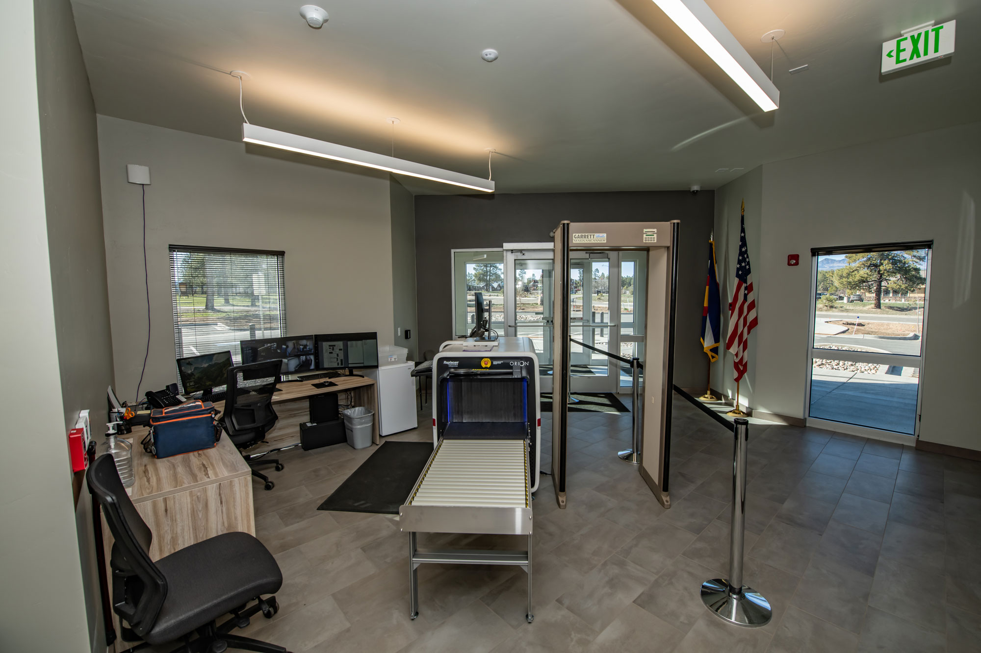 Interior view of Reynolds Ash + Associates office with security scanner and workstations.