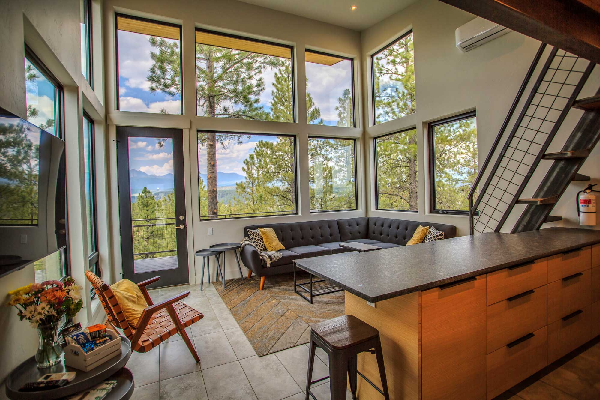 Bright living room with large windows and scenic mountain views.
