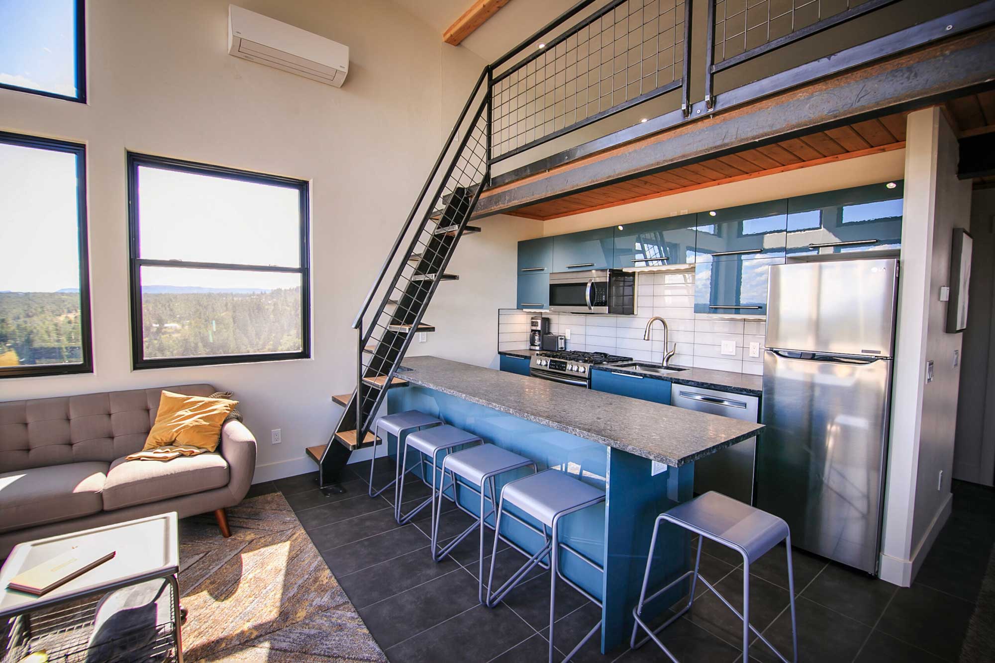 Modern cabin interior with open kitchen and loft in Cedar Creek Cabins.