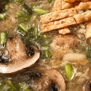 Close-up of smoky Tajín chicken and bean salad with fresh herbs and spices.