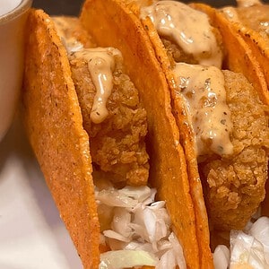 Delicious crispy shrimp tacos with spicy sauce, perfect for Girl Dinner.