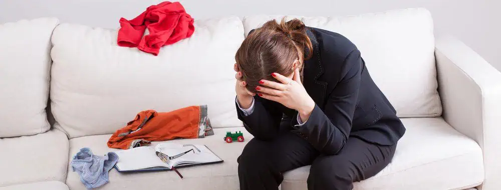 Exhausted woman Exhausted woman surrounded by the detritus of her busy life, needing someone to say to her they will redesign your life