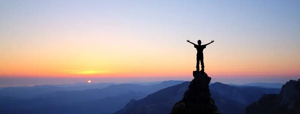 Man mountain Silhouette of a man on top of a mountain celebrating success