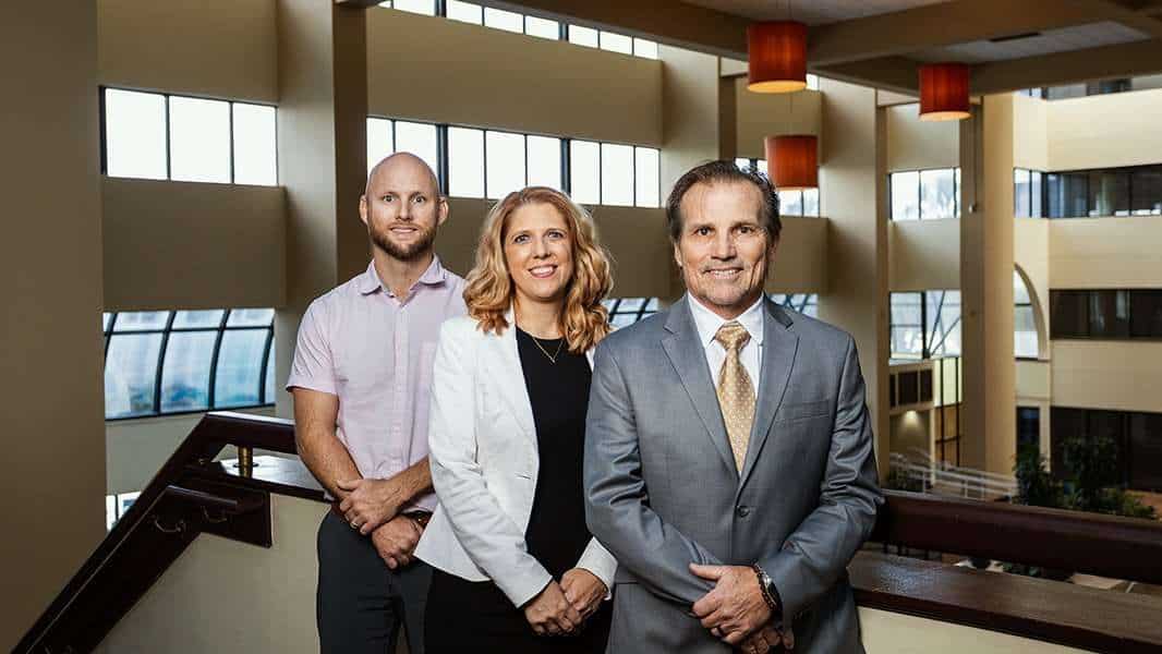 Professional team of lawyers at Romano Law Group in modern office setting.