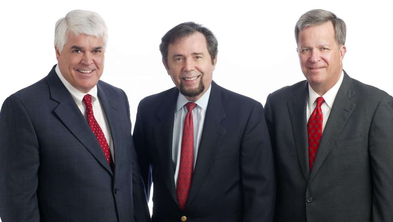 Romano Law Group team of three professional attorneys in suits.