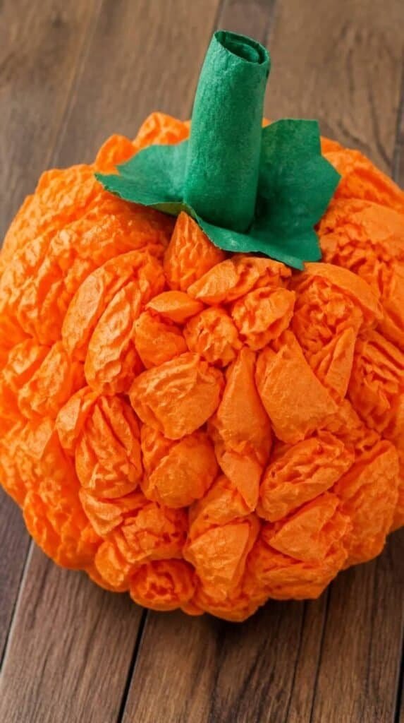 Tissue paper pumpkin craft with textured orange paper