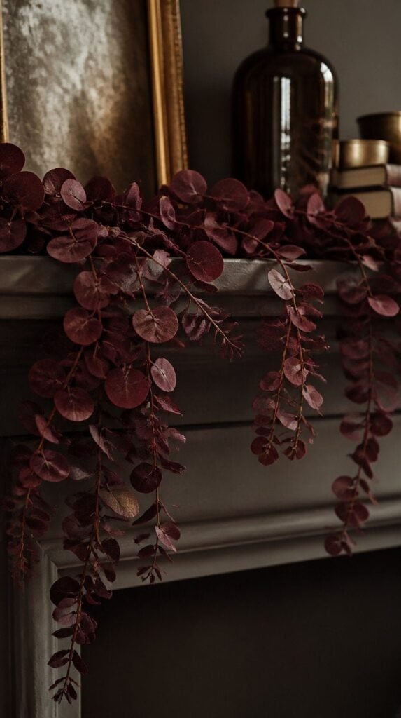 Dried eucalyptus garland dyed deep burgundy draped along a shelf edge