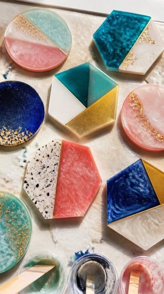 Colorful handmade resin coasters drying on a craft table - crafts under 10
