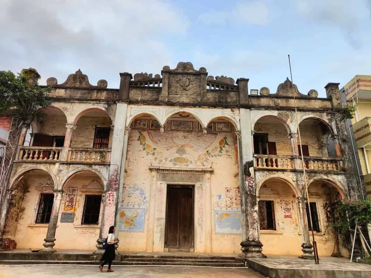 Heritage building in the Enping–Kaiping qiaoxiang with an arched facade and murals — remittance-built architecture of the Wuyi emigrant villages