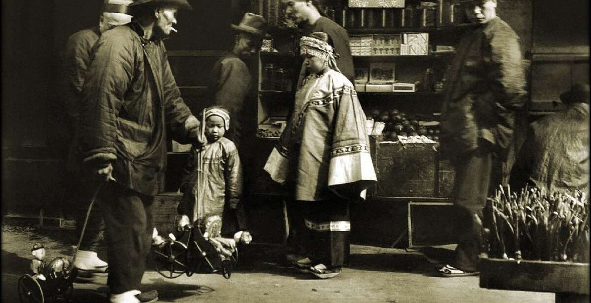 A toy vendor in San Francisco's Chinatown, photographed by Arnold Genthe around 1900, capturing the daily life of the Chinese American community during the Exclusion era