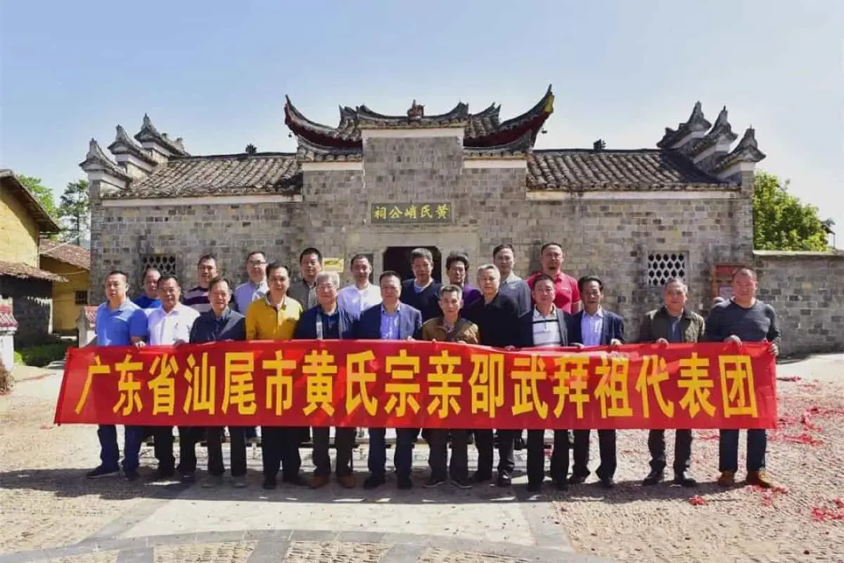 Contemporary Huang clan members participating in ancestral veneration ceremonies at a restored ancestral hall in Taishan, part of the ongoing roots-searching tourism movement reconnecting diaspora descendants with their villages of origin