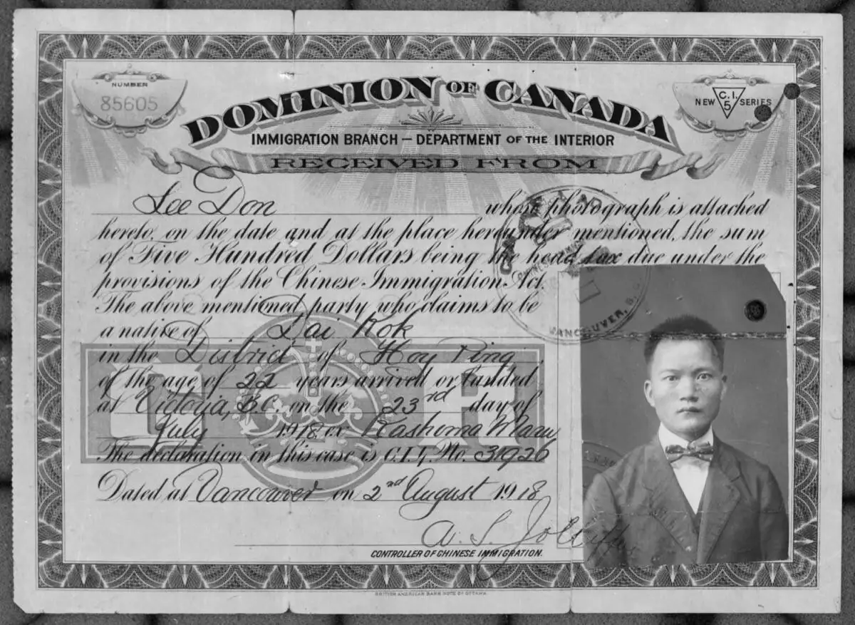 Head tax certificate of Chinese immigrant Lee Don, issued 1918 in Vancouver, with his portrait and the $500 receipt stamp