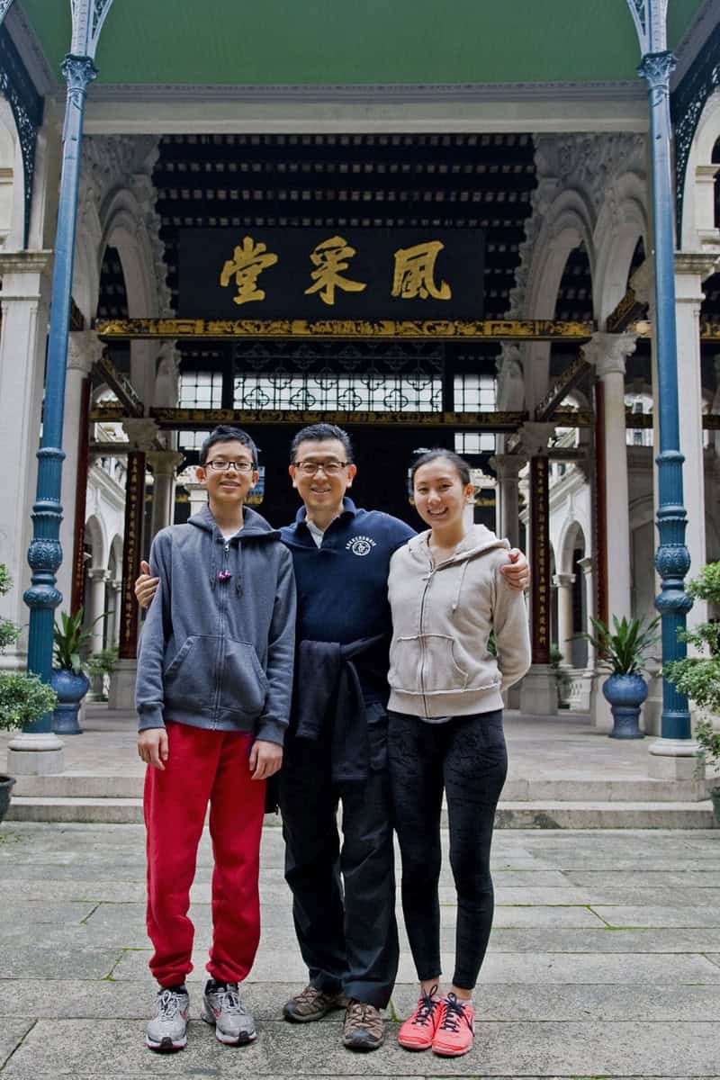 Main entrance of the Dihai Fengcai Hall with visiting descendants, arched gateway and red couplet banners