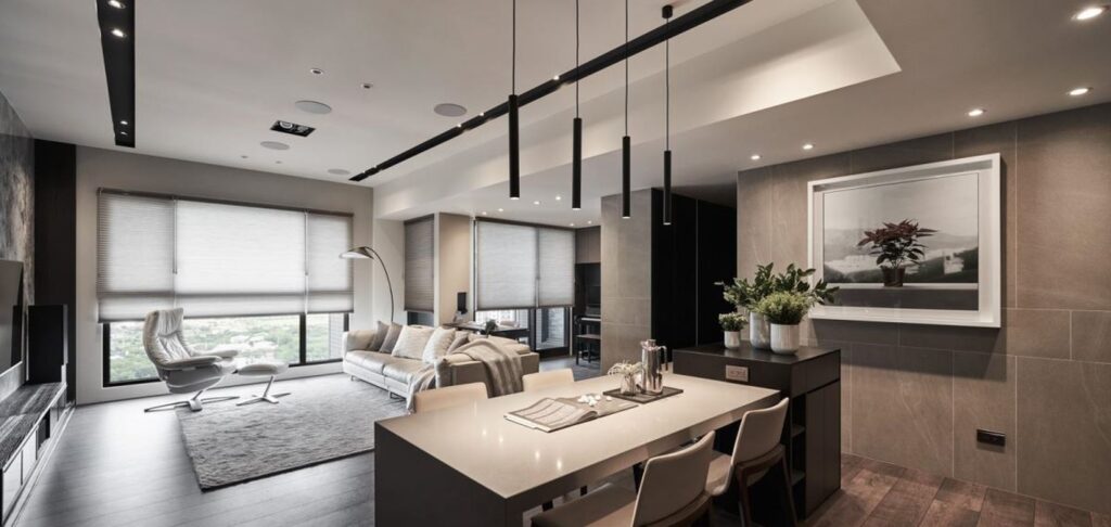 Modern open-plan living and dining area with sleek furniture and lighting.