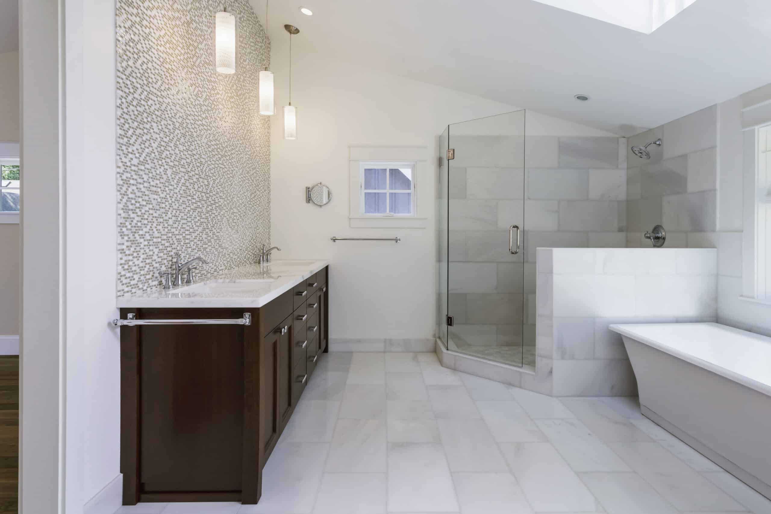 Modern bathroom with double vanity, glass shower, and freestanding tub.