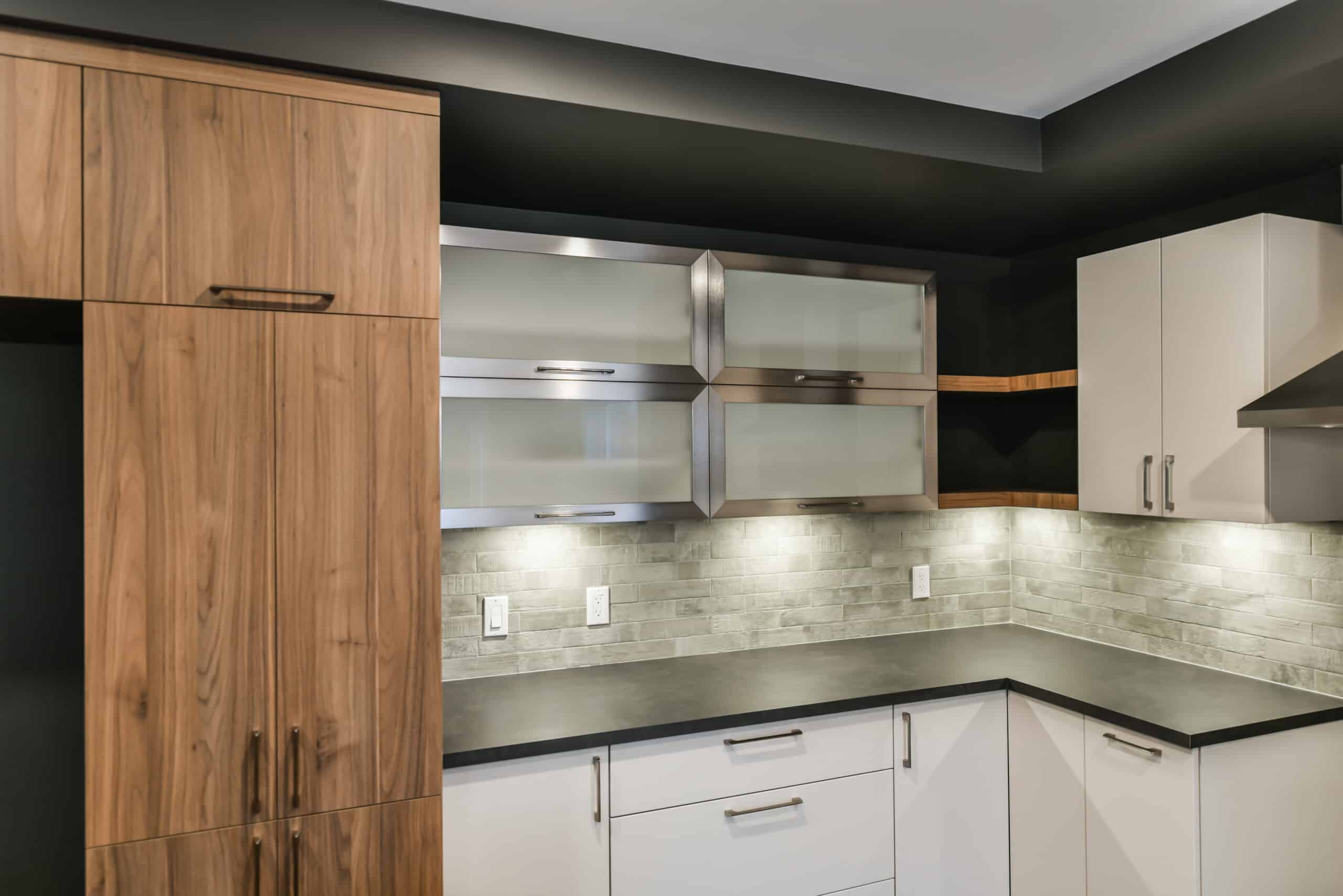 Modern kitchen with wood cabinets, white cabinets, and frosted glass cabinets.