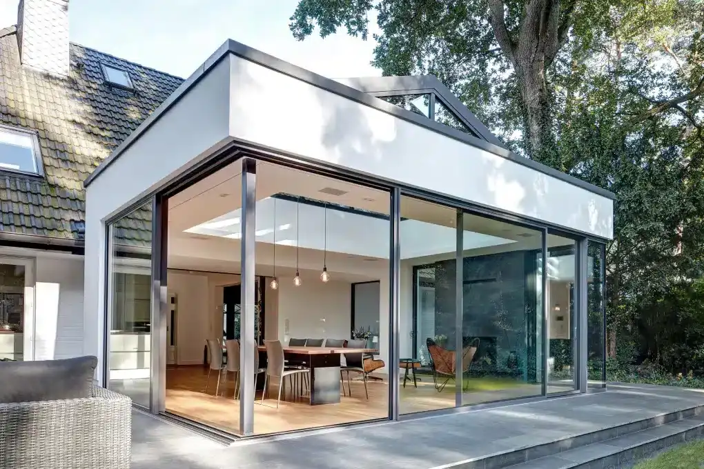 Modern glass extension on a house with a dining area and living space