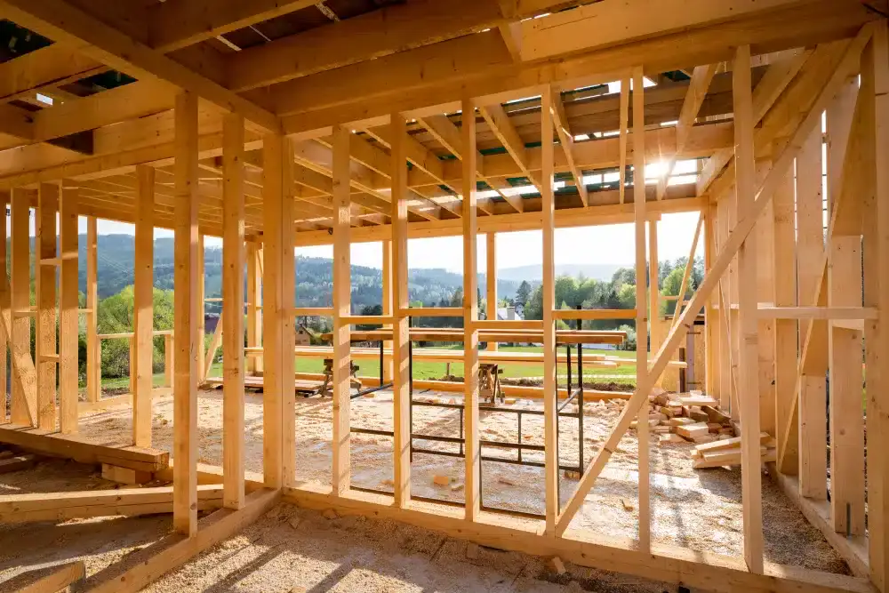 Interior view of a house under construction with visible wooden framing.
