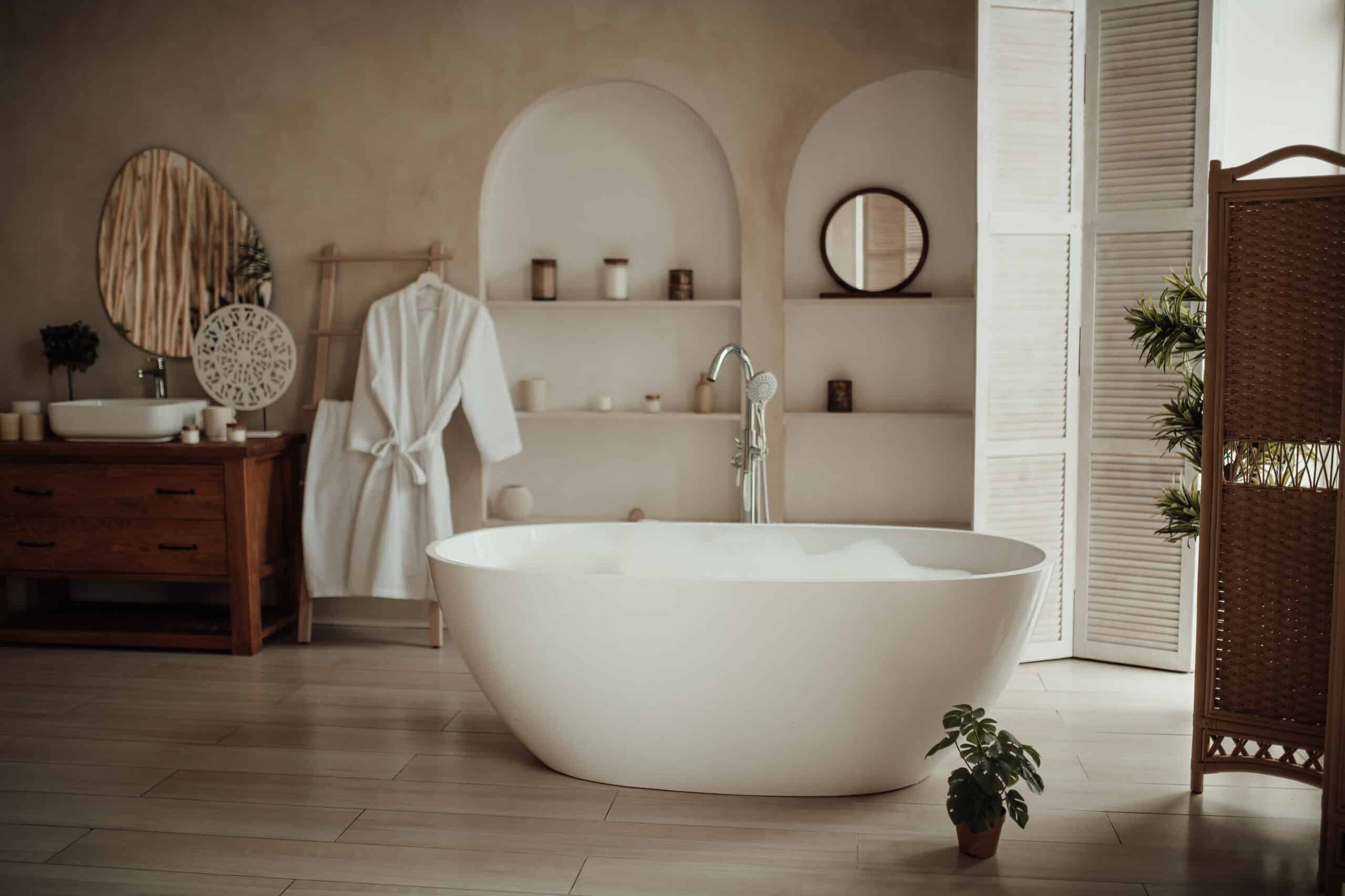 A white bathtub with bubbles in a modern bathroom with natural decor.