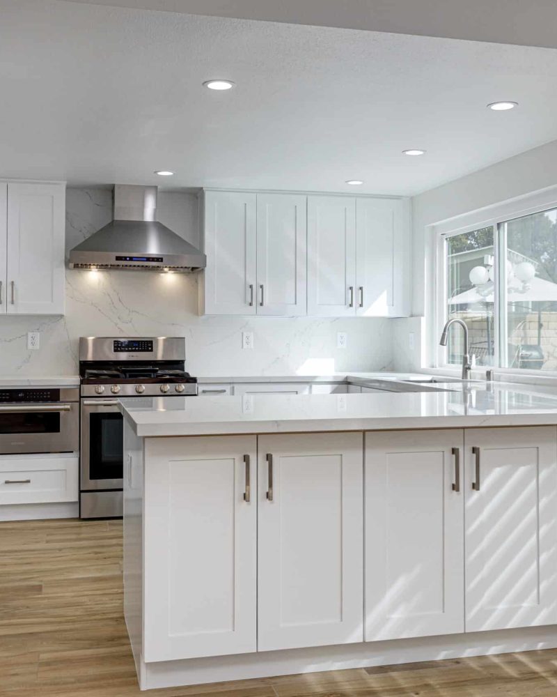 Modern white kitchen with stainless steel appliances and island
