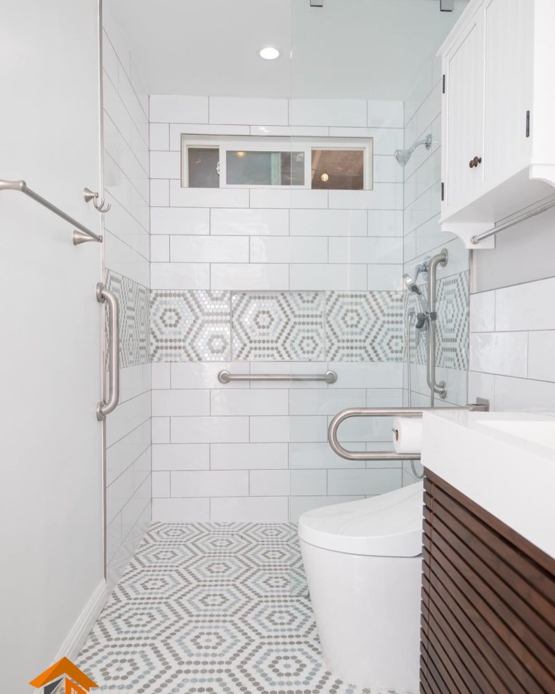 Accessible bathroom with walk-in shower, grab bars, and toilet.