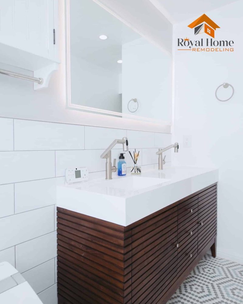Modern bathroom vanity with white countertop, wood cabinet, and large mirror.