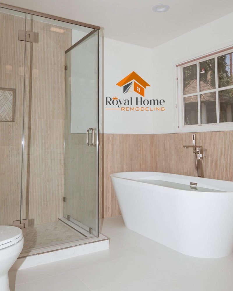 Modern bathroom with a glass shower, freestanding tub, and toilet.