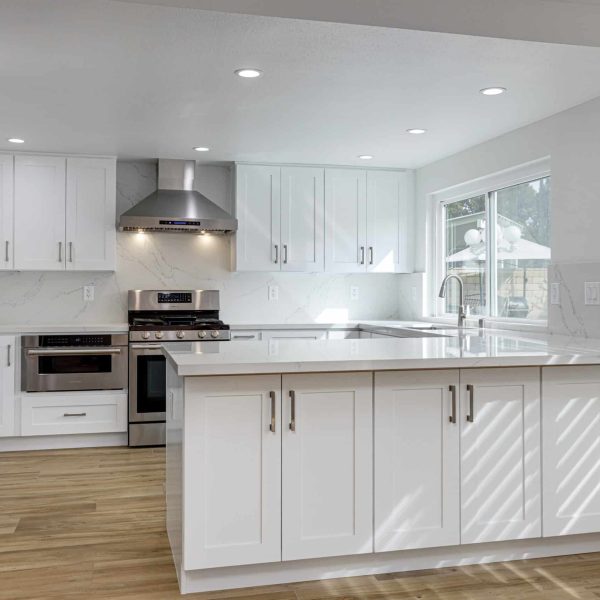 Modern white kitchen with stainless steel appliances and island