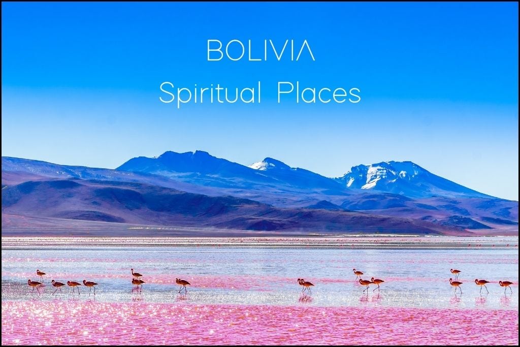 Find Your Spiritual Places in South America A group of flamingos wades through the red waters of Laguna Colorada in Bolivia, with striking mountains in the backdrop under a clear blue sky. 'Spiritual Places in BOLIVIA' implies a journey through Bolivia's otherworldly landscapes and the spiritual tranquility they offer.