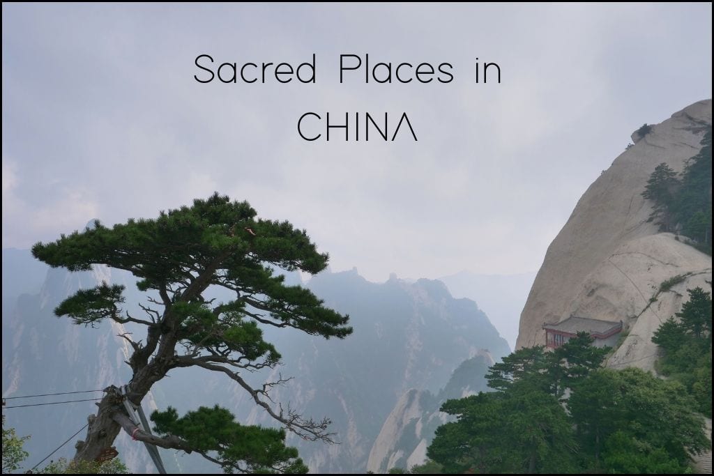 A serene view of a mountainous landscape in China with the words 'Sacred Places in CHINA' overlaid at the top. A lone, robust pine tree stands prominently in the foreground, while rugged peaks and a traditional pagoda-style structure cling to the steep, misty slopes in the background.