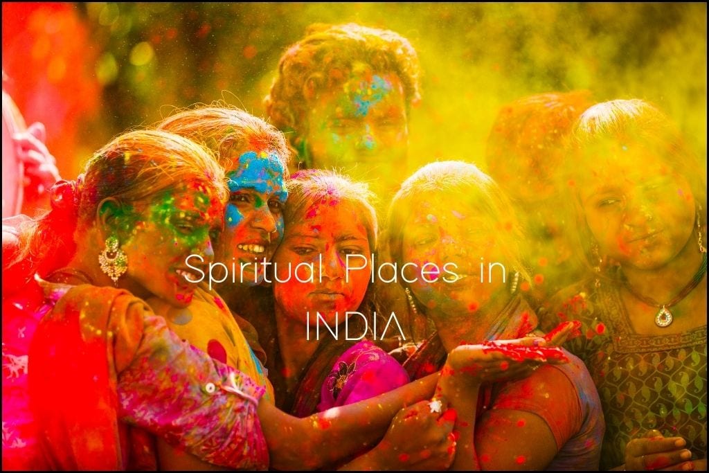Spiritual Places in Asia A group of joyous people covered in vibrant colors celebrate at a spiritual festival in India, with 'Spiritual Places in INDIA' text overlay. The photograph captures the exuberance and communal spirit of the celebration, with faces smeared in reds, yellows, and greens, and smiles that reflect the country's cultural richness.