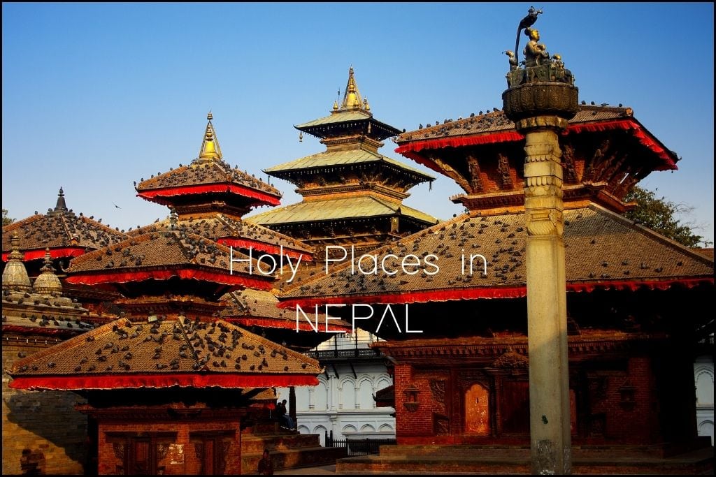 Spiritual Places in Asia Multi-tiered pagoda-style temples with deep red and gold roofs in Kathmandu, Nepal, under 'Holy Places in NEPAL'. The temples feature intricate carvings and statues, with a bustling atmosphere that hints at a rich cultural heritage.