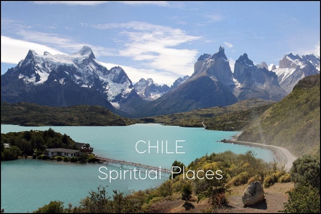 Find Your Spiritual Places in South America The breathtaking Torres del Paine National Park in Chile, with its iconic sharp peaks rising behind a turquoise lake and a solitary building connected by a wooden pier, under a clear blue sky. 'Spiritual Places in CHILE' indicates the blog post may cover the awe-inspiring natural beauty of Chilean landscapes.