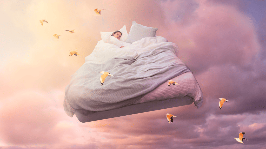 Cedar Waxwing Symbolism (Meaning, Totem & Dreams) A dreamlike composition featuring a person asleep on a floating bed high in the sky amidst a surreal pink and purple cloud-scape, with birds resembling Cedar Waxwings symbolizing freedom and the tranquility of dreams.