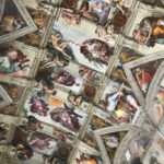 Spiritual Quest St. Peter Basilica (Vatican City) The ceiling of the Sistine Chapel in Vatican City, featuring Michelangelo's iconic frescoes, including The Creation of Adam, surrounded by intricate depictions of biblical stories and vibrant details.