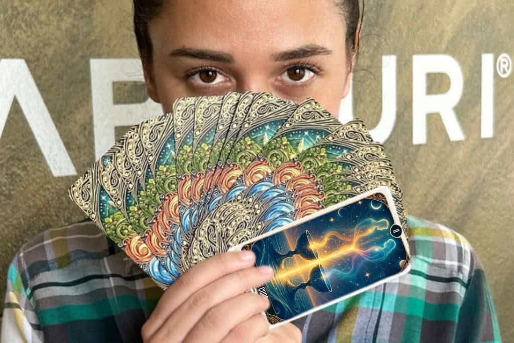 What Does Cups Represent in Tarot? Your Heartfelt Guide! A person holds a fan of ornate tarot cards close to their face, with the Two of Cups card visible at the front. The artwork shows two glowing figures rising from chalices, symbolizing love, connection, and the emotional themes of the Suit of Cups in tarot.